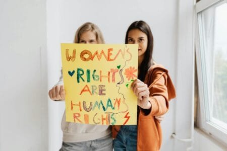 women holding a poster