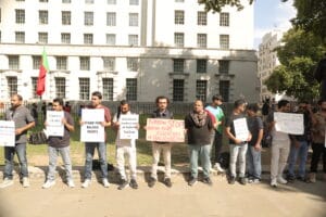 Aomar Karim holding placard “Pakistan Stop Human Rights Violations in Balochistan” at Pledge Renewal Day Rally, London, 2025.